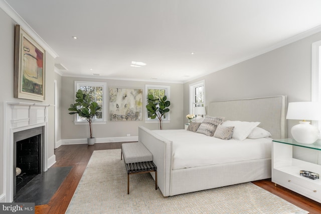 bedroom with crown molding and hardwood / wood-style flooring