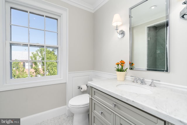 bathroom featuring tile patterned floors, ornamental molding, toilet, and vanity