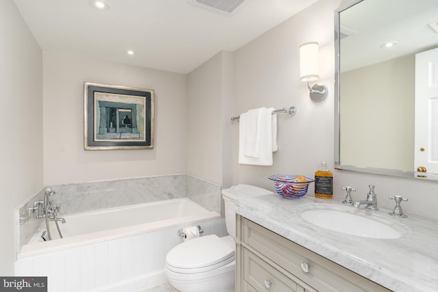 bathroom featuring vanity, toilet, and a washtub