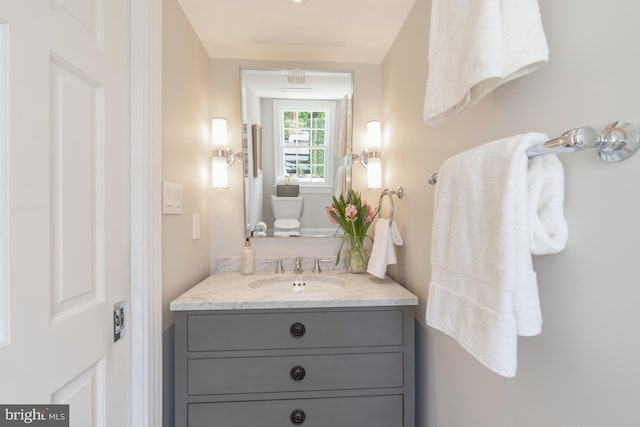 bathroom featuring vanity and toilet