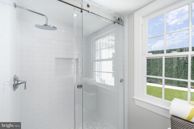 bathroom with a healthy amount of sunlight and a shower with shower door