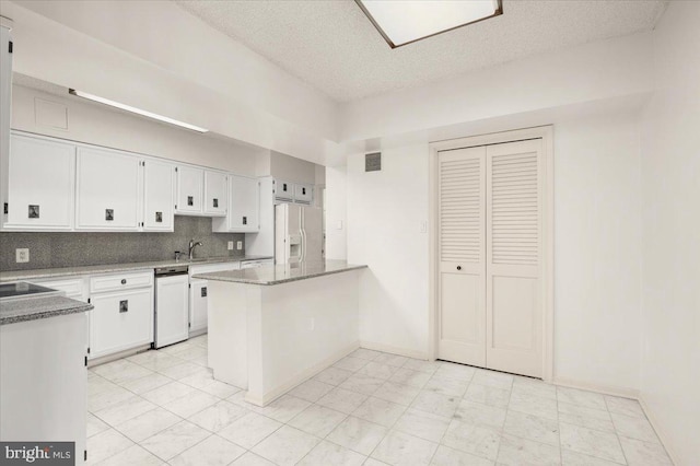 kitchen with backsplash, white cabinets, white fridge with ice dispenser, a textured ceiling, and kitchen peninsula