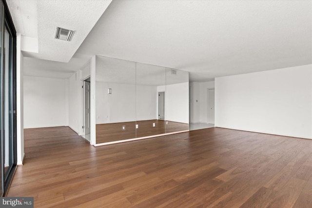 empty room featuring hardwood / wood-style floors and a textured ceiling