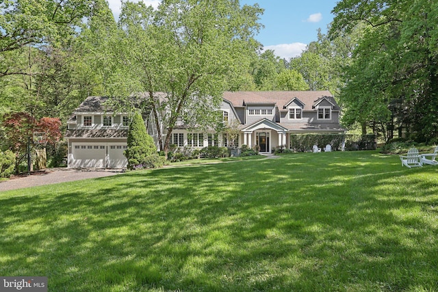 view of front of house featuring a garage and a front yard