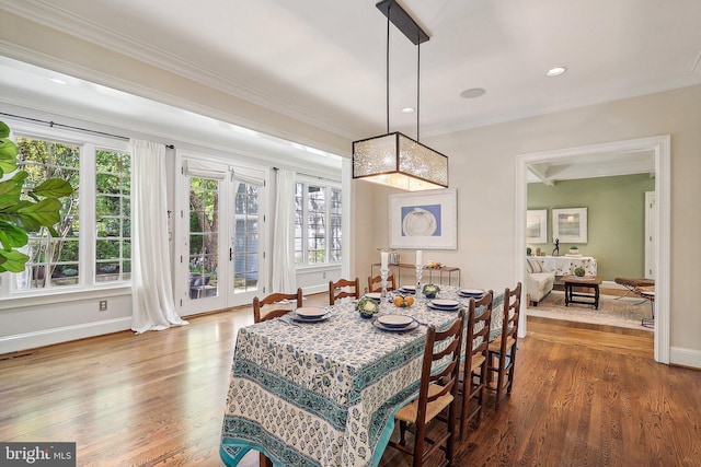 dining room with crown molding and hardwood / wood-style flooring