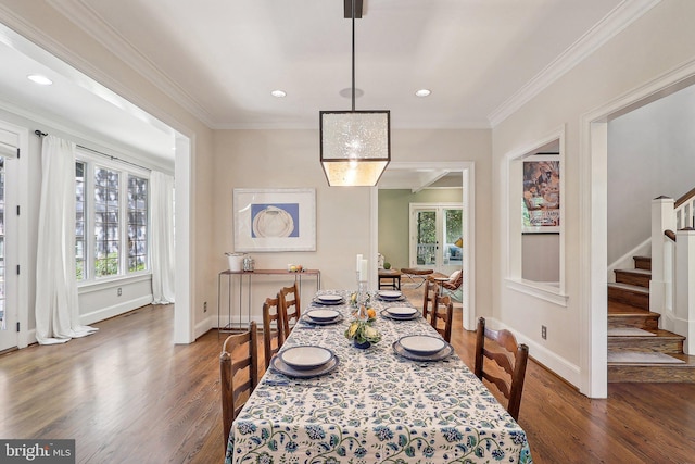 dining area with crown molding and dark wood-type flooring