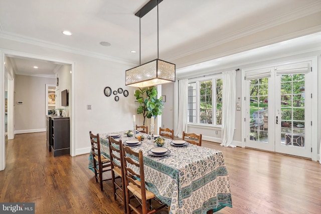 dining space featuring crown molding and dark hardwood / wood-style flooring