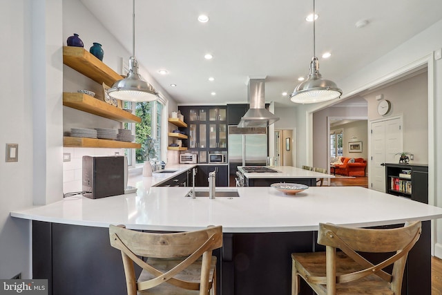 kitchen with hanging light fixtures, sink, and a kitchen bar