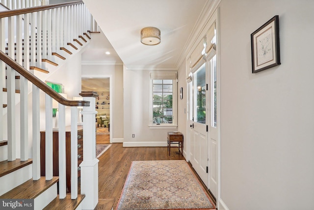 foyer featuring crown molding and dark wood-type flooring