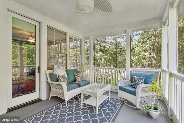 sunroom featuring ceiling fan