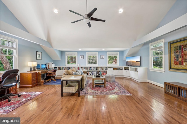 living room featuring high vaulted ceiling, ceiling fan, and light wood-type flooring