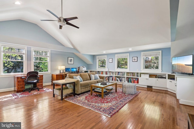 living room featuring hardwood / wood-style flooring, plenty of natural light, and vaulted ceiling