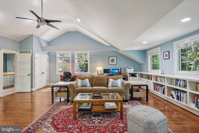 living room featuring lofted ceiling, hardwood / wood-style floors, and ceiling fan