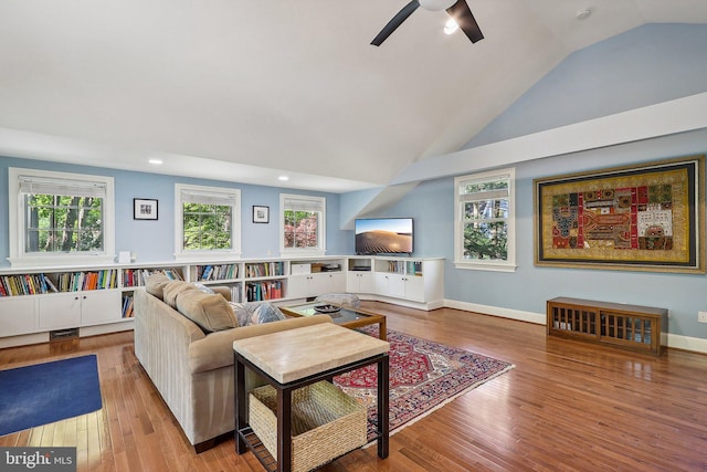 living room with lofted ceiling, ceiling fan, and light hardwood / wood-style flooring