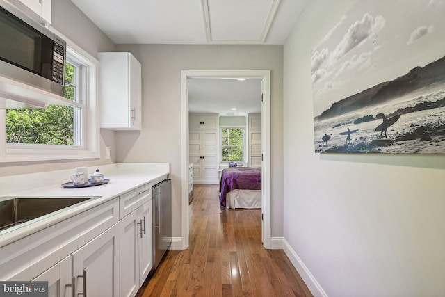 kitchen featuring white cabinetry and wood-type flooring