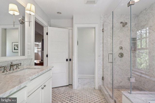 bathroom featuring vanity and a shower with shower door