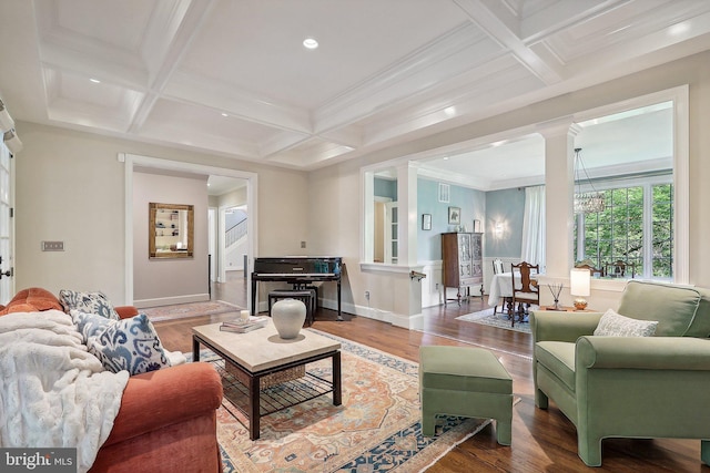 living room with beamed ceiling, ornamental molding, wood-type flooring, and coffered ceiling