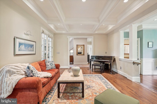 living room featuring coffered ceiling, hardwood / wood-style floors, ornamental molding, and beamed ceiling