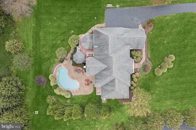 aerial view of property and surrounding area with a pool area