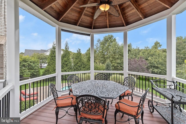 sunroom / solarium featuring a ceiling fan and plenty of natural light