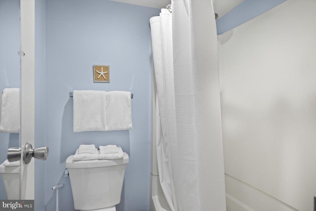 bathroom with shower / bath combo and toilet