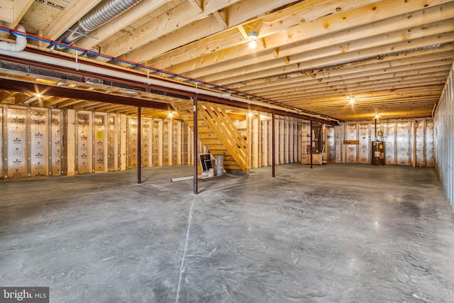 unfinished below grade area with water heater and stairs