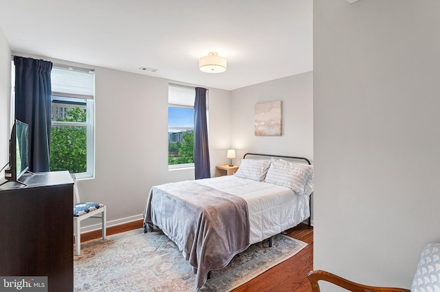 bedroom with hardwood / wood-style floors