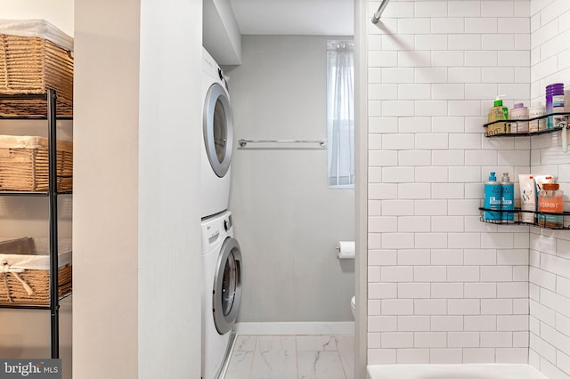 laundry room with light tile flooring and stacked washer / drying machine