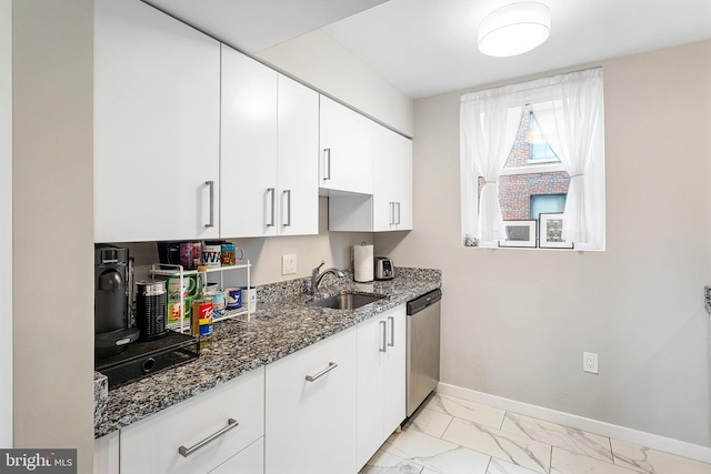 kitchen featuring light tile floors, white cabinets, sink, dark stone counters, and stainless steel dishwasher