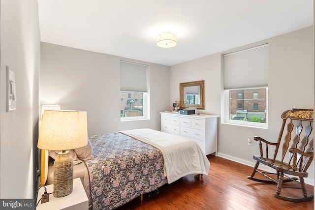 bedroom featuring dark hardwood / wood-style flooring and multiple windows