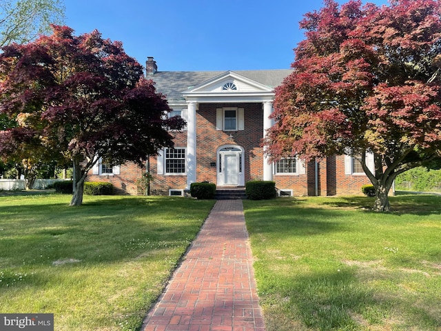 greek revival inspired property with a front lawn