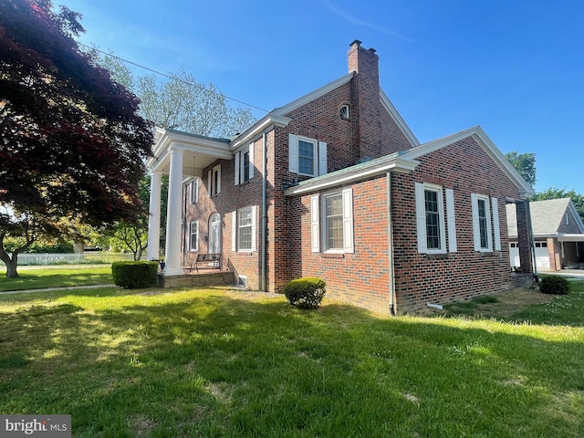 rear view of house with a lawn