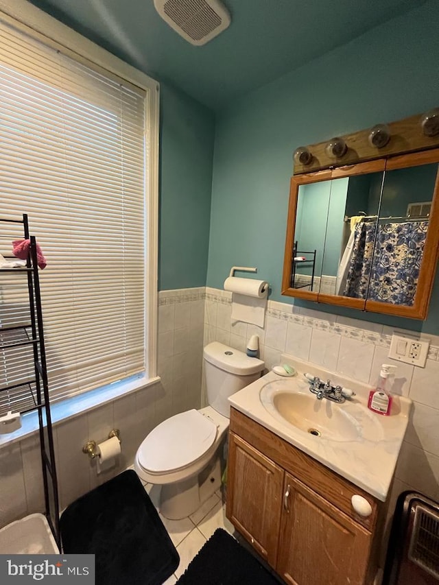 bathroom with tile walls, backsplash, toilet, tile flooring, and vanity