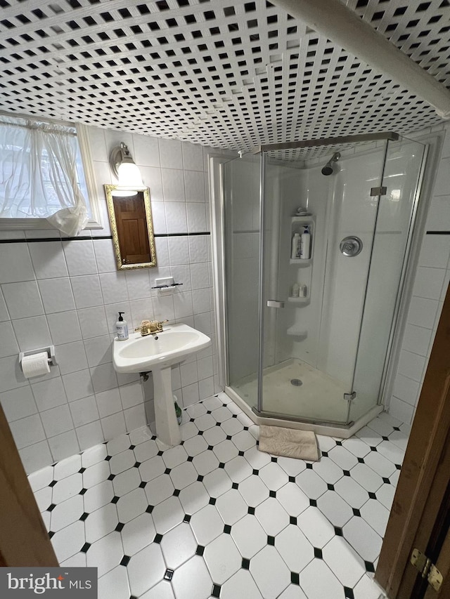 bathroom featuring walk in shower, tile flooring, and tile walls