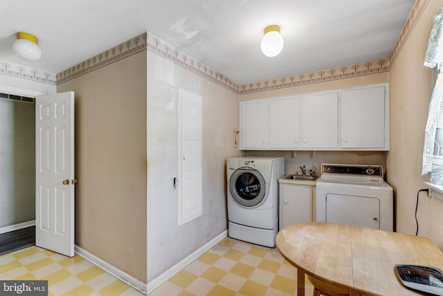 washroom with independent washer and dryer, sink, and light tile floors