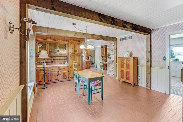 dining area with beam ceiling