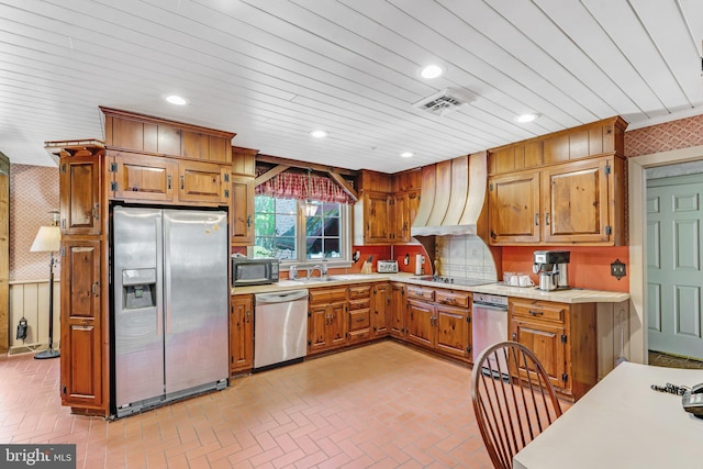 kitchen with premium range hood, tasteful backsplash, sink, and black appliances