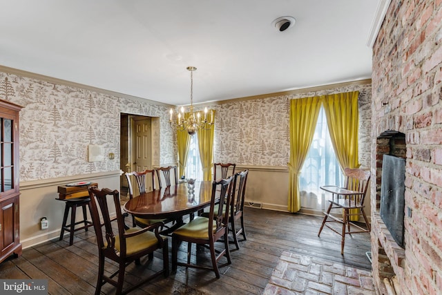 dining room with a notable chandelier, dark hardwood / wood-style flooring, and crown molding