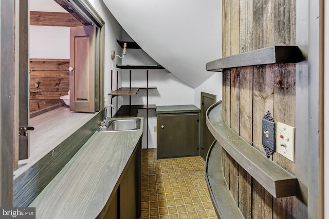 kitchen featuring tile flooring and sink