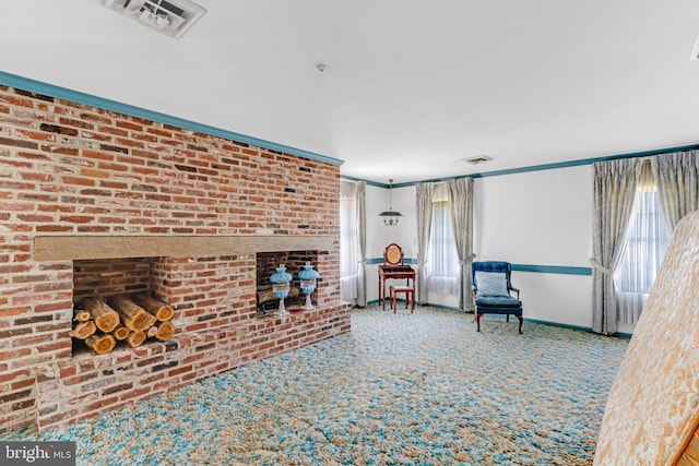 unfurnished living room featuring brick wall, carpet floors, and a fireplace