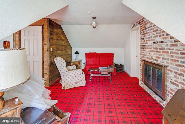 interior space featuring lofted ceiling and a fireplace