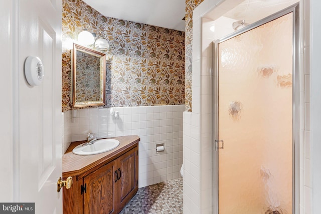 bathroom featuring tile walls, an enclosed shower, tile floors, and vanity with extensive cabinet space