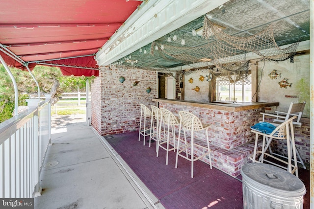 view of terrace featuring an outdoor bar