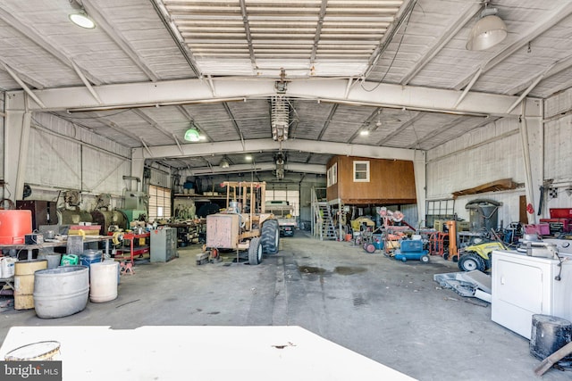 garage with a workshop area and washer / clothes dryer