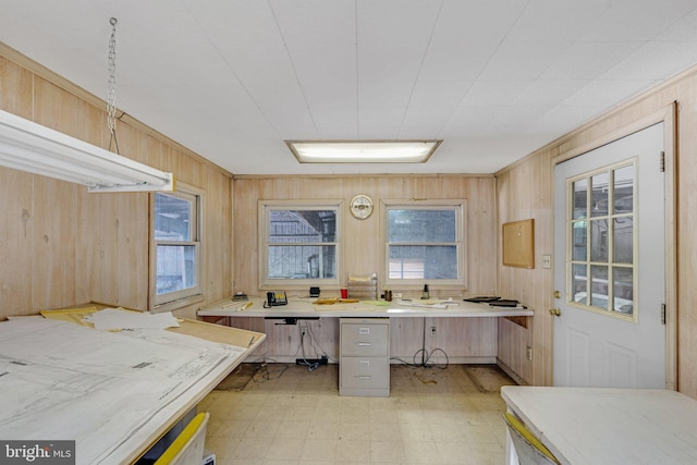 kitchen with wood walls and light tile floors