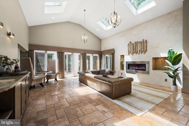 tiled living room featuring a skylight, a notable chandelier, and high vaulted ceiling