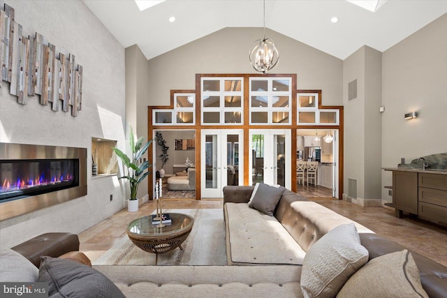 tiled living room with high vaulted ceiling, french doors, and an inviting chandelier