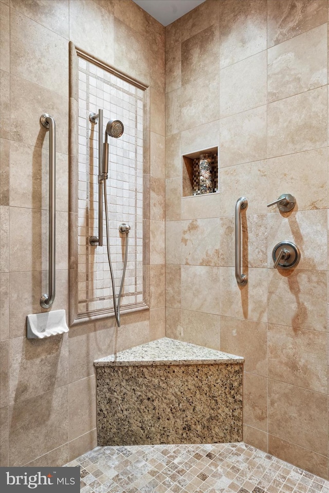 bathroom with tiled shower