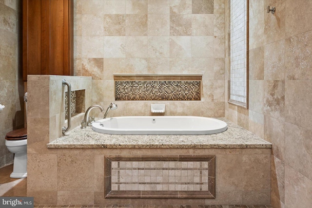 bathroom featuring toilet, a bathing tub, and tile walls