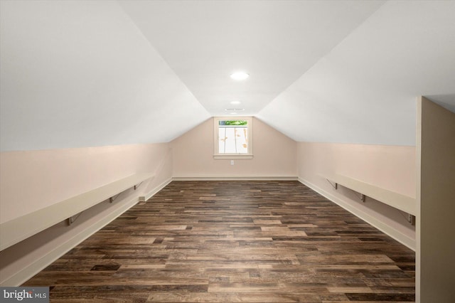 bonus room with dark hardwood / wood-style floors and lofted ceiling